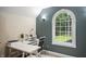Bright home office features a modern white desk and chair, complemented by a large window offering wooded views at 2034 Dynasty Ridge Rd, Martinsville, IN 46151