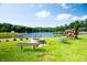 Picturesque lake view featuring a fire pit and seating area surrounded by lush greenery and a serene waterfront at 2034 Dynasty Ridge Rd, Martinsville, IN 46151