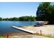 Scenic lakefront access with a wooden dock and a rack of colorful canoes, perfect for enjoying water activities at 2034 Dynasty Ridge Rd, Martinsville, IN 46151