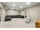 Finished basement living room with large sectional sofa and a comfortable rocking chair at 2034 Dynasty Ridge Rd, Martinsville, IN 46151