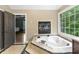 Relax in the luxurious soaking tub with a fireplace in this serene main bathroom retreat at 2034 Dynasty Ridge Rd, Martinsville, IN 46151