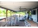 Covered outdoor seating with tables, chairs, ceiling fans and TVs overlooking the lake at 2034 Dynasty Ridge Rd, Martinsville, IN 46151