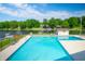 Beautiful community pool with lake view, lounge chairs and meticulously maintained deck at 2034 Dynasty Ridge Rd, Martinsville, IN 46151