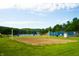 Sandy volleyball court with a lake view and lush green surroundings at 2034 Dynasty Ridge Rd, Martinsville, IN 46151