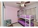A purple room with hardwood floors, fun bunk beds, and a ceiling fan at 2170 N Old State Road 9, Columbus, IN 47203