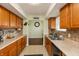 Well-lit kitchen featuring wood cabinets, neutral countertops, and tile flooring for easy maintenance at 2170 N Old State Road 9, Columbus, IN 47203