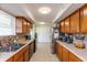 Functional kitchen featuring ample cabinet space, tile flooring, and a stainless steel refrigerator at 2170 N Old State Road 9, Columbus, IN 47203