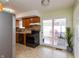 Functional kitchen with wood cabinets, a black stove, and a door to a bright outdoor space at 2170 N Old State Road 9, Columbus, IN 47203