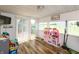 A sun room with hardwood floors, backyard access, and lots of windows at 2170 N Old State Road 9, Columbus, IN 47203