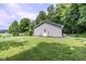 View of house backyard showing green lawn, mature trees, and siding on house at 2246 E Yellowwood Ln, Martinsville, IN 46151