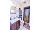 Bathroom with wood vanity, sink, mirror, toilet, cabinet and shower with curtain at 2246 E Yellowwood Ln, Martinsville, IN 46151