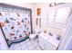 This bathroom has a shower with curtain, sink with storage, toilet and light fixtures at 2246 E Yellowwood Ln, Martinsville, IN 46151