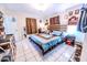 Large bedroom with wood-style bed, white tile floor, ceiling fan, and natural lighting at 2246 E Yellowwood Ln, Martinsville, IN 46151