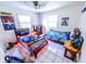 This bedroom contains two beds, ceiling fan, windows, tile floor and sports decor at 2246 E Yellowwood Ln, Martinsville, IN 46151