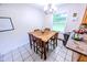 Cozy dining area with wooden table and chairs, complemented by natural light and tile floors at 2246 E Yellowwood Ln, Martinsville, IN 46151
