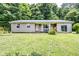 Charming single-story home with a metal roof, covered porch, and partially wooded front yard at 2246 E Yellowwood Ln, Martinsville, IN 46151