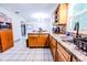 Functional kitchen featuring wood cabinetry, ample counter space, and tile flooring at 2246 E Yellowwood Ln, Martinsville, IN 46151