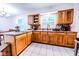 Efficient kitchen layout with light wood cabinets, tile backsplash, and an open design at 2246 E Yellowwood Ln, Martinsville, IN 46151