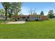 Expansive backyard featuring lush green lawn, mature trees, and a patio perfect for outdoor enjoyment at 227 Vestal Rd, Plainfield, IN 46168