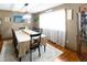 Dining room with hardwood floors, bright window, and a classic china cabinet at 227 Vestal Rd, Plainfield, IN 46168