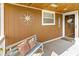 Inviting front porch with a cozy bench, decorative pillows, and nautical themed compass rose at 227 Vestal Rd, Plainfield, IN 46168