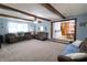 Open-concept living room with exposed beams and a view into the kitchen area at 227 Vestal Rd, Plainfield, IN 46168