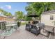 Back deck with table, chairs, BBQ, bench seating, and umbrella at 253 W Westfield Blvd, Indianapolis, IN 46208