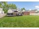 Spacious backyard with well-kept lawn, deck, and perimeter fencing at 253 W Westfield Blvd, Indianapolis, IN 46208