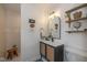 Stylish bathroom with decorative mirror, sleek vanity, open shelving, and tiled shower at 253 W Westfield Blvd, Indianapolis, IN 46208