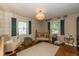 Bright, cheerful bedroom with charming decor, hardwood floors, and classic wooden crib at 253 W Westfield Blvd, Indianapolis, IN 46208