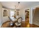 Elegant dining room featuring hardwood floors, stylish lighting, and access to the kitchen and staircase at 253 W Westfield Blvd, Indianapolis, IN 46208