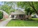 Charming brick home featuring a well-manicured lawn and beautiful landscaping, perfect for curb appeal at 253 W Westfield Blvd, Indianapolis, IN 46208