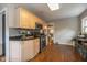 Well-lit kitchen featuring hardwood floors, light wood cabinets, and stainless steel appliances at 253 W Westfield Blvd, Indianapolis, IN 46208