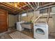 Basement laundry room with washer, dryer, utility sink, concrete floor, and natural light at 253 W Westfield Blvd, Indianapolis, IN 46208