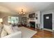 Cozy living room with a fireplace, a large window, and hardwood floors at 253 W Westfield Blvd, Indianapolis, IN 46208