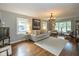 Bright living room with hardwood floors, neutral decor, and large windows offering plenty of natural light at 253 W Westfield Blvd, Indianapolis, IN 46208