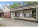 Inviting porch with black accents, rocking chairs, and ample space for relaxing and enjoying the outdoors at 253 W Westfield Blvd, Indianapolis, IN 46208