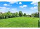 Spacious and well-maintained backyard with lush green grass and a mature tree line at 2715 Benmore Ct, Zionsville, IN 46077