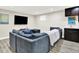 Basement living area with a large comfy sectional couch, flat screen tv and wet bar for entertaining at 2715 Benmore Ct, Zionsville, IN 46077