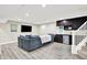 Finished basement featuring a comfortable seating area and a wet bar with dark cabinets and a mini fridge at 2715 Benmore Ct, Zionsville, IN 46077