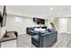 Finished basement with a large gray sectional sofa and wet bar perfect for entertaining at 2715 Benmore Ct, Zionsville, IN 46077