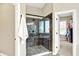 This is a walk-in shower with glass doors, tile surround and a view into a walk-in closet at 2715 Benmore Ct, Zionsville, IN 46077