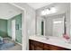 Bathroom featuring a single sink vanity with a large mirror and a view into an adjacent bedroom at 2715 Benmore Ct, Zionsville, IN 46077