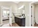 A bathroom with a granite vanity, dark wood cabinets and a view into the Primary bedroom at 2715 Benmore Ct, Zionsville, IN 46077