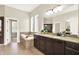 A bathroom featuring tile floors, granite counters, double sinks and a jacuzzi style bathtub at 2715 Benmore Ct, Zionsville, IN 46077