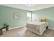 Charming bedroom with pale green walls, a large window, and soft, neutral-toned carpet at 2715 Benmore Ct, Zionsville, IN 46077
