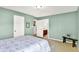 Well-lit bedroom features a bed and access to a connected bathroom with a wooden bench at 2715 Benmore Ct, Zionsville, IN 46077