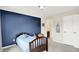 This bedroom has a blue wall with neutral carpet, plus decor, toys and a wooden bed at 2715 Benmore Ct, Zionsville, IN 46077