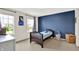 Cozy bedroom with a blue accent wall, two windows, and a hardwood bed frame at 2715 Benmore Ct, Zionsville, IN 46077