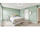 Light-filled bedroom with pale green walls, a comfortable bed, and neutral decor at 2715 Benmore Ct, Zionsville, IN 46077
